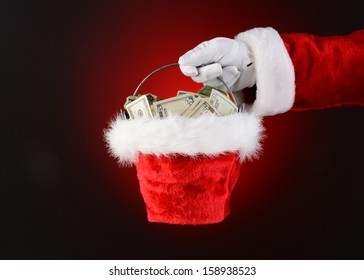 Closeup Of Santa Claus Holding A Bucket Of Cash.