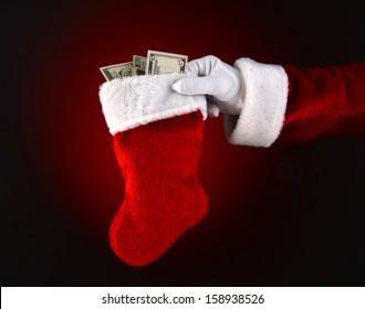 Closeup Of Santa Claus Holding A Stocking Full Of Cash. 