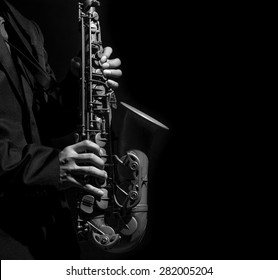 Closeup saxophone in player action on a dark background, black and white tone