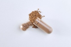 Closeup of the scatter powder from capsule. Isolated pill, a Health & Medical Photo by Andrew Sotnikow