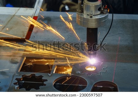 Close-up scene the laser cutting machine cutting  machine cut the metal plate with laser beam marking. The hi-technology sheet metal manufacturing process by laser cutting machine. 