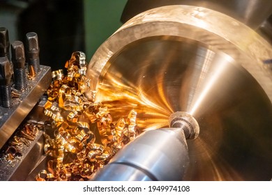 Close-up scene of lathe machine cutting the  brass material metal  parts with the cutting tools. The metalworking process by turning machine. - Powered by Shutterstock