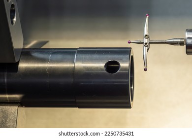 Closeup scene the modular touch probe checking the tube parts on CNC lathe machine. The quality control of turning parts with CMM probe. - Shutterstock ID 2250735431