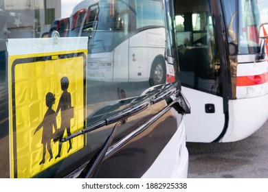Close-up of school bus parked on a plot of land