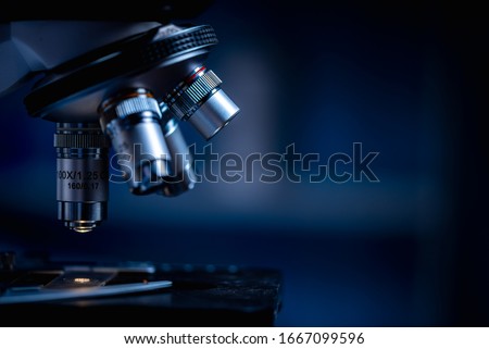 Closeup of Scientific microscope data analysis in the laboratory, study for making vaccine to protection a coronavirus COVID-19