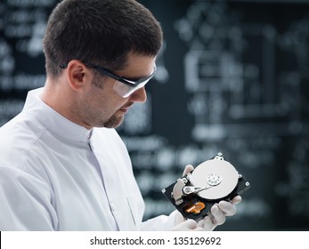 Close-up Of A Scientist In A Chemistry Lab Analyzing A Hard Disk