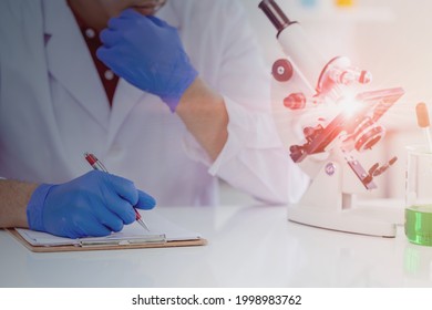 Closeup Scientist Thinking And Taking Note Report For Science Medical Research Memo In Paper Or Check Listing At Medicine Laboratory.