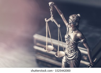 Closeup of a sculpture of Themis, mythological Greek goddess, symbol of justice, blind and holding empty balance in her hand - Shutterstock ID 1525442000