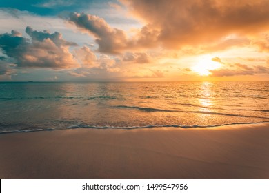 Closeup of sea beach and colorful sunset sky. Panoramic beach landscape. Empty tropical beach and seascape. Orange and golden sunset sky, soft sand, calmness, tranquil relaxing sunlight, summer mood - Powered by Shutterstock