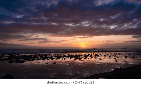 Close-up of sea sand on a tranquil beach in Japan. Panoramic view of a colorful sunset sky and serene seascape with dramatic sky. Ideal for vacation and holiday themes. Sunset ocean. - Powered by Shutterstock