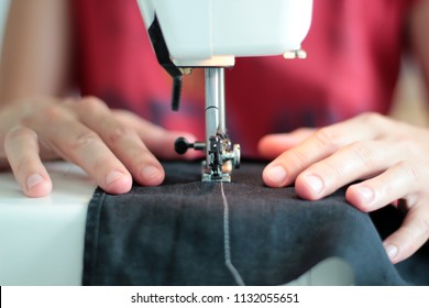 Close-up seamstress hands working on sewing machine at home. Sewing process. woman hands behind sewing close-up. - Shutterstock ID 1132055651