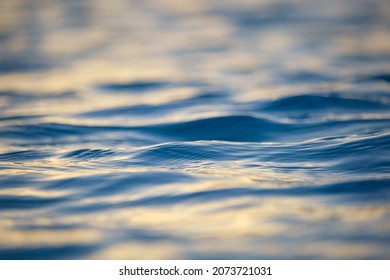 Closeup seascape surface of blue sea water with small ripple waves.