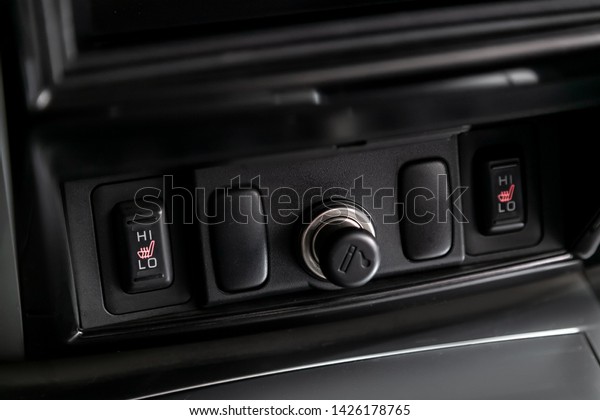 Close-up of seat heating buttons\
and charging in the car, cigarette lighter. Modern car\
interior\
\
