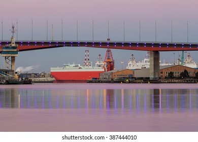 Closeup of section of Bolte bridge in Melbourne and a large red cargo ship in early morning. - Powered by Shutterstock