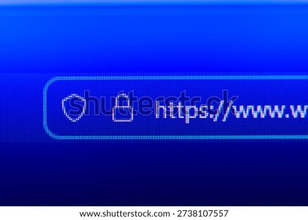 Close-up of a secure web browser address bar with HTTPS protocol, padlock icon, and shield symbol, representing internet security, data privacy, and encrypted connection.