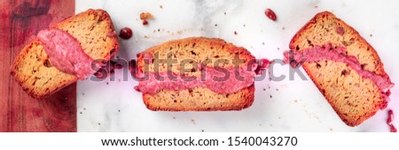 A close-up of a seed cake with ruby chocolate, shot from above