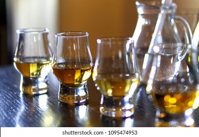 Close-up / Selective Focus A Flight Of Whiskies. Four Different Whiskies In Whisky Tasting Glasses.