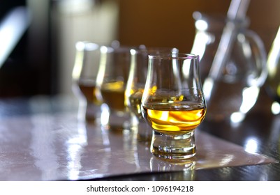 Close-up / Selective Focus A Flight Of Whiskies. Four Different Whiskies In Whisky Tasting Glasses.