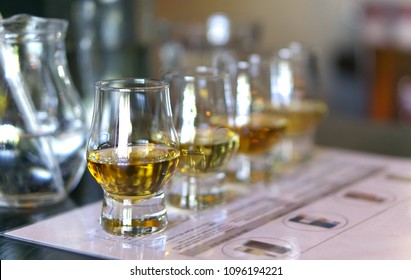 Close-up / Selective Focus A Flight Of Whiskies. Four Different Whiskies In Whisky Tasting Glasses.