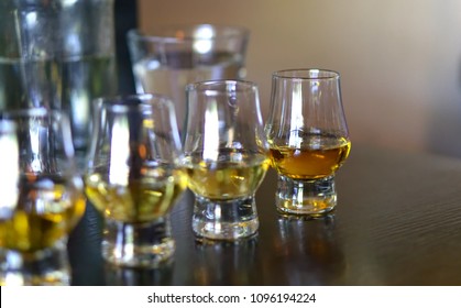 Close-up / Selective Focus A Flight Of Whiskies. Four Different Whiskies In Whisky Tasting Glasses.