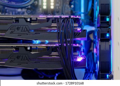 Close-up and selective focus high performance dual Graphic Card installed on Computer PC Desktop with multicolored LED RGB light show status on working mode, interior DIY on PC Case - Shutterstock ID 1728910168