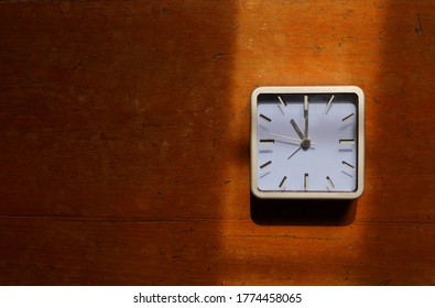 Closeup and selective focus on clock hands at eleven, the eleventh hour concept metaphor 