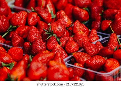 Close-up of a selective focus of ripe strawberries on the counter. Strawberries are sold in boxes as a healthy food. Top view of delicious, fresh, juicy strawberries, just picked. Juicy berries.
