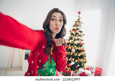 Closeup selfie photo of young adorable pretty lovely girl curly brown hair wear red ugly comfortable sweater pouted lips air kiss you indoors