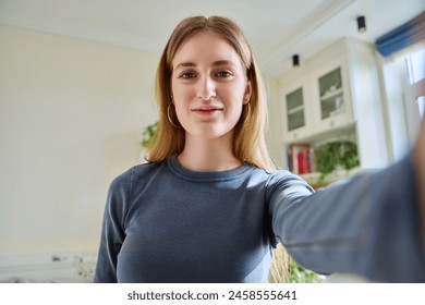 Close-up selfie portrait of teenage cheerful female looking at web camera - Powered by Shutterstock
