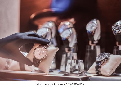 Close-up Of The Seller's Hand In Gloves Shows The Exclusive Men's Watch From The New Collection In The Luxury Jewelry Store