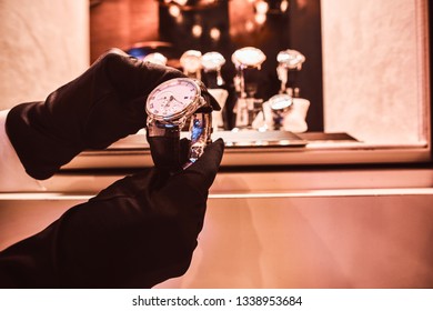 Close-up Of The Seller's Hands In Gloves Shows The Exclusive Men's Watch From The New Collection In The Luxury Jewelry Store