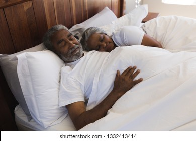 Close-up Of A Senior African American Couple Sleeping Together In Bedroom At Home