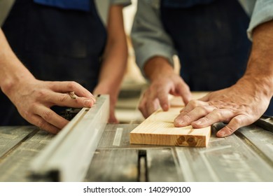 Closeup of senior carpenter working with apprentice in joinery workshop, copy space