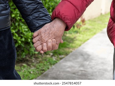 Close-Up of Senior Couple Holding Hands - Powered by Shutterstock