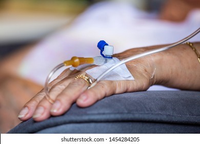 Close-up of senior hand with venous catheter. Close up hand of old patient with intravenous catheter for injection plug in hand