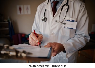 Closeup Of Senior Male Doctor Writing Notes On The Clipboard In The Hospital - Doctor Writing Script