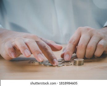 Closeup Senior Man Hand Counting Coin To Saving Money For Retirement Financial And Pension Annuity Insurance. Concept For Loan,property,financial.