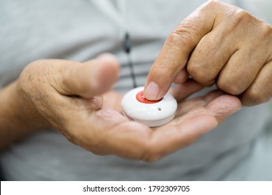 Close-up Of Senior Man Pressing Alarm Button For Emergency