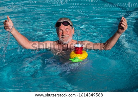 Similar – Ein Mann mit Sonnenhut und einer gelben Gummiente in einem Pool.