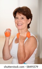 Closeup Of Senior Woman Lifting Weights