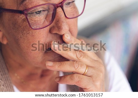 close-up of senior woman smoking a cigarette