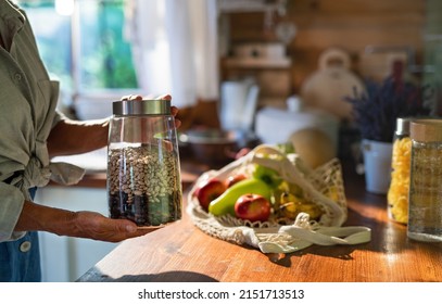 Close-up of senior woman unpacking local food in zero waste packaging from bag in kitchen at home. - Powered by Shutterstock