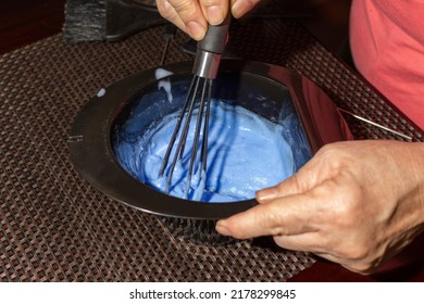 Close-up Of A Senior Woman's Hands Making A Hair Dye Mixture In A Black Bowl