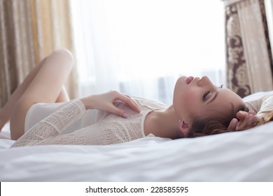 Close-up Of Sensual Woman Lying On Bed