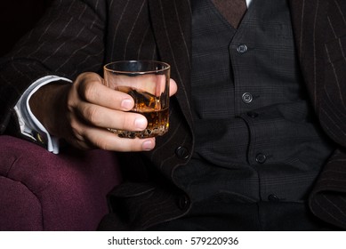 Closeup Of Serious Businessman Holding Whiskey Illustrate Executive Privilege Concept