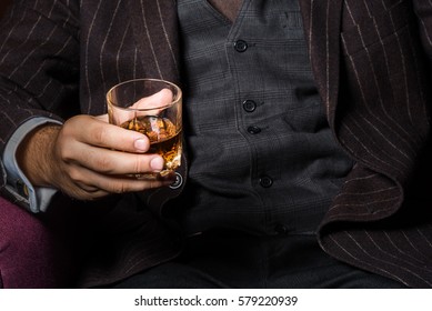 Closeup Of Serious Businessman Holding Whiskey Illustrate Executive Privilege Concept