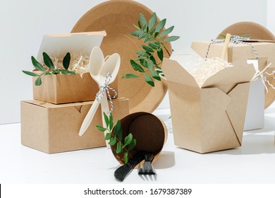 A Close-up Set Of Eco-friendly Tableware Packaging Decorated With Leafs, And Cutlery Made Of Corn Starch On A White Background