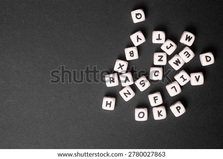 A close-up of a set of plastic letter cubes