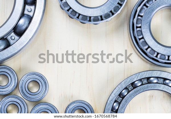 Closeup, Set of steel ball bearings on\
wooden plate, Top view with copyspace for your\
text\
