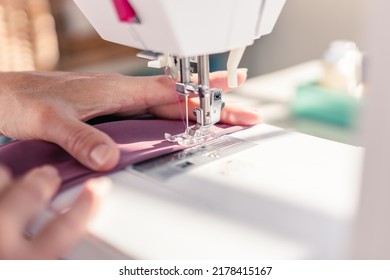 close-up of sewing machine needle sewing a piece of fabric - Powered by Shutterstock